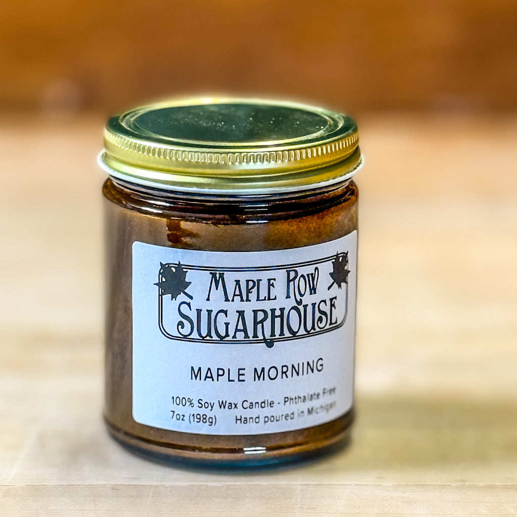 Jar of Maple Row Sugarhouse candle on a wooden surface